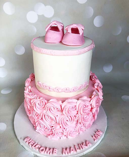 Pink and White Cake with Adorable Baby Shoes