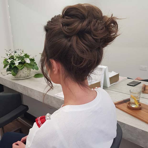 Chic High Bun with Relaxed Curls